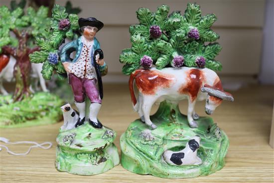 A Walton pottery sheep and lamb spill vase, two Staffordshire pottery cow and calf groups & a Staffordshire of a youth and his dog (4)